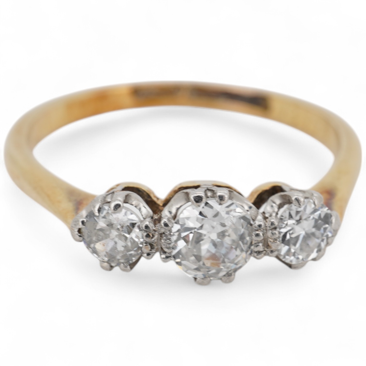 An 18ct, plat. and three stone diamond set ring, size O, gross weight 2.4 grams.